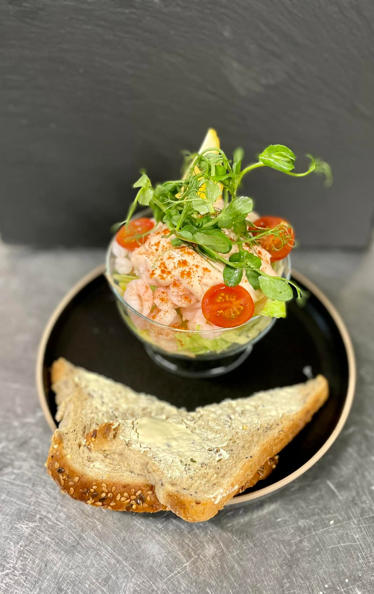 A prawn cocktail with pea shoots and buttered granary bread