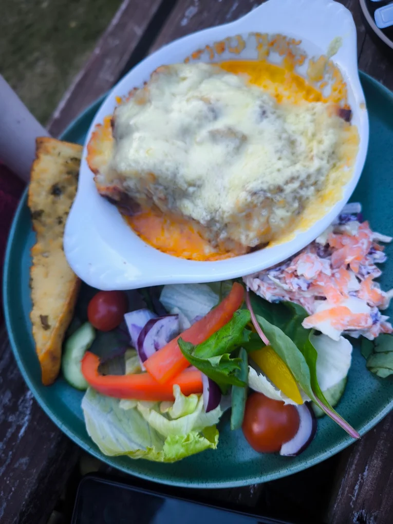 Lasagne baked golden, served with garlic bread, salad and coleslaw