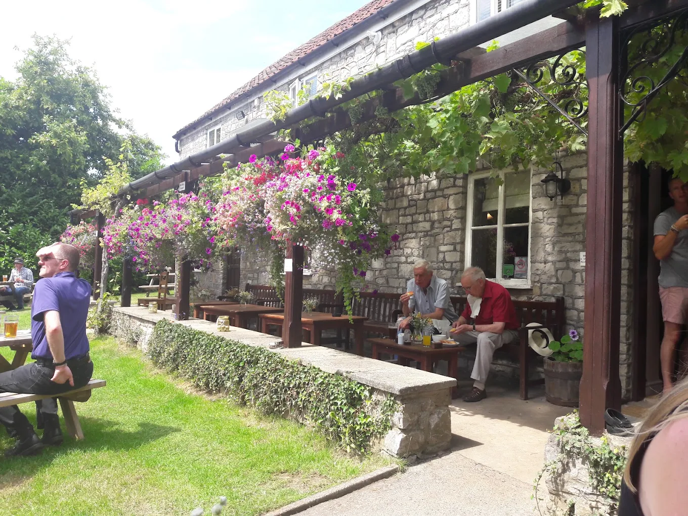 Hanging baskets in full flower along the veranda at The Fox Inn in summer
